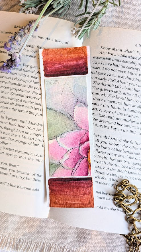 Handmade bookmark featuring bold reddish-brown colour blocks and a central hand-painted pink flower.