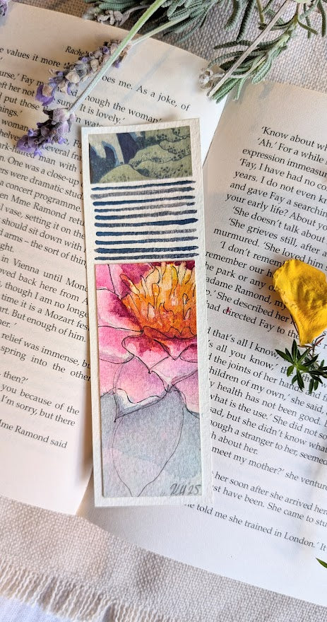 Vibrant hand-painted bookmark with warm sunset-coloured petals and blue linear accents, created on recycled paper
