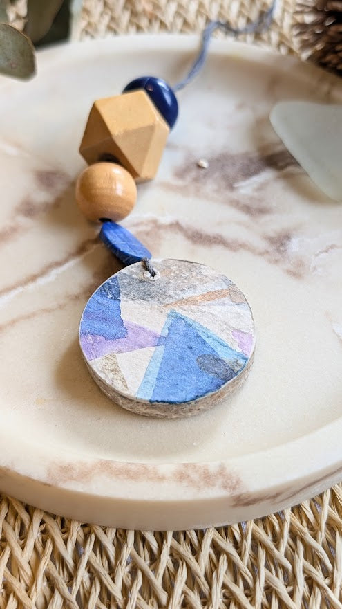 Decorative pendant with geometric design on a marble surface