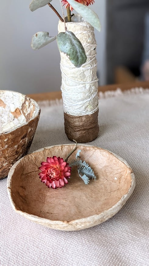 Flower sitting in hand made paper clay dish