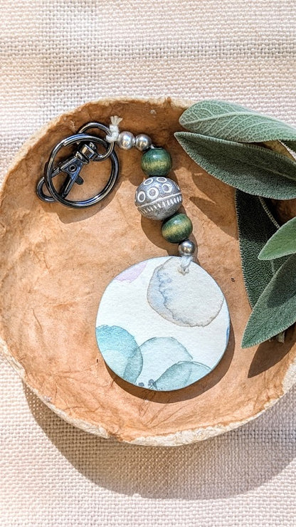 Green beaded keyring with watercolour flowers