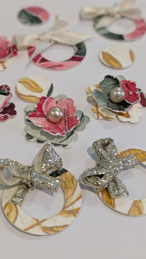 earrings with floral and bow designs on a white background