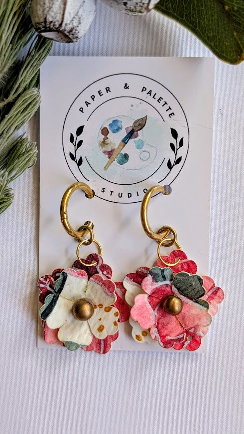Floral earrings on a 'Paper & Palette Studio' branded card with greenery in the background.