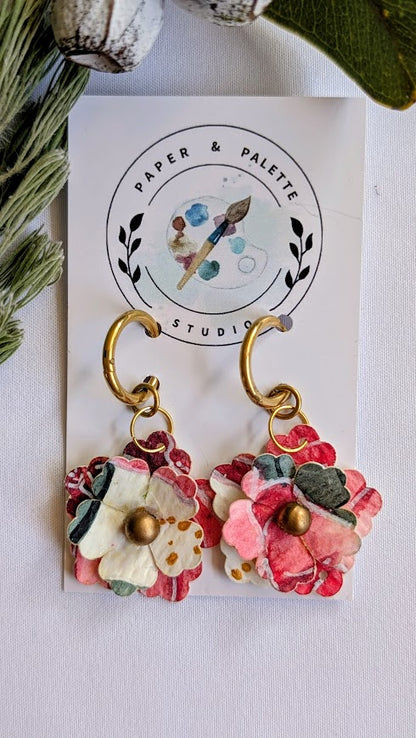 Floral earrings on a 'Paper & Palette Studio' branded card with greenery in the background.
